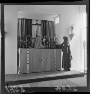 Unidentified nun at church altar, Little Sisters of Assumption convent and nursing home