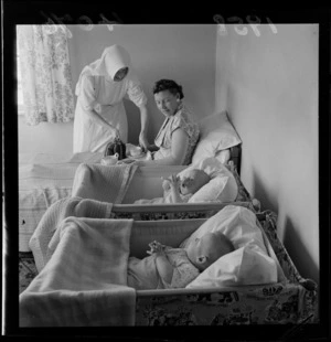 Unidentified woman and babies, being cared for by a nun at Little Sisters of Assumption nursing home, Petone, Wellington