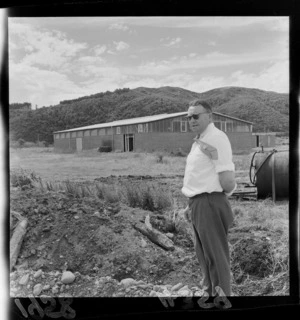 Unidentified man standing outside the Taita Rugby Union Football Club gymnasium, Lower Hutt