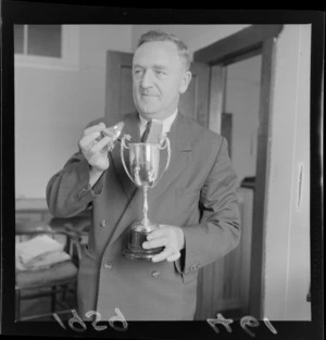 Lieutenant Colonel H McKenzie Reid holding an urn containing ashes
