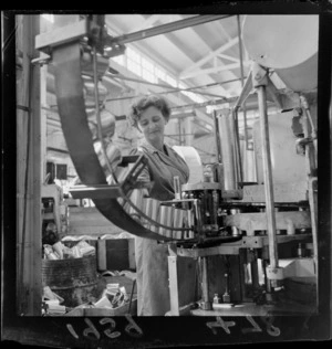 Unidentified woman checking cans in a factory in Lower Hutt