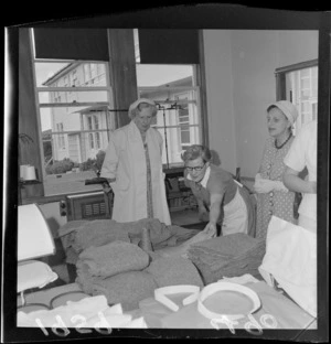 Unidentified member of the staff showing visitors a room in Arohata Borstal, Porirua, during a visit by Lady Cobham
