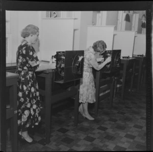 Two unidentified women working the machinery of the totalisator, [Trentham Racecourse, Upper Hutt?]