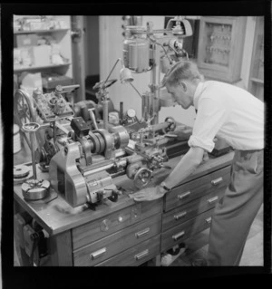 Unidentified man working the machinery of the totalisator, [Trentham Racecourse, Upper Hutt?]