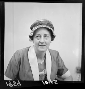 Portrait of Helen Hampton, who is wearing a hat and pearls