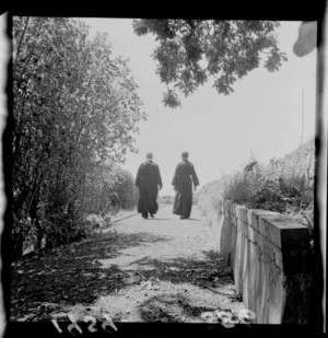 Two unidentified monks walking along a garden path at St Gerard's Monastery, Wellington