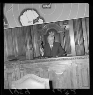 Prime Minister Walter Nash, Chairman of the South East Asian Treaty Organisation, holding a mere at the closing of the Wellington conference, including world map in background