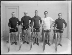 Studio portrait of five unidentified male cyclists in riding attire with road racing bicycles, Christchurch