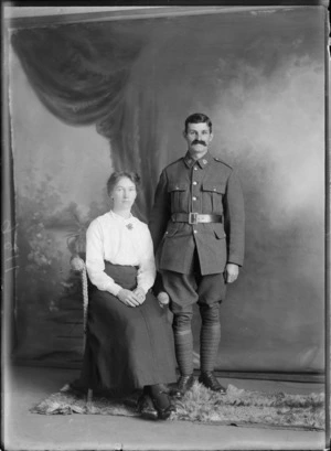Studio portrait of an unidentified man and woman, showing the man wearing a military uniform, possibly Christchurch district