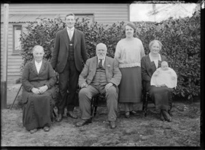 Family group, showing two men and three women, one holding a baby, all unidentified, outdoors, possibly Christchurch district