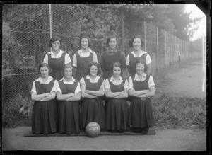 Hastings Girls High, school basketball team in uniforms, COG [Convent Old Girls] on ball, Hastings, Hawke's Bay District