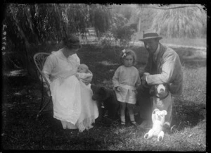 Colley family photo in backyard, baby and young daughter with stuffed toy animals, Hawke's Bay District