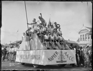 New Napier Week Carnival, men & women dressed as athletes on truck float, with signs 'Napier AA & CC, No Prize But Honour', Napier, Hawke's Bay District