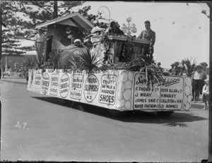 New Napier Week Carnival, people dressed in costumes on truck float of the 'Woman who lived in a shoe', with signs for Napier Shoe Store, Marine Parade, Napier, Hawke's Bay District