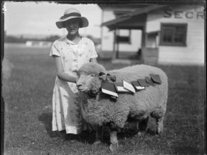 View of a young lady [Manson?] kneeling with her prize winning sheep, Hawke's Bay District