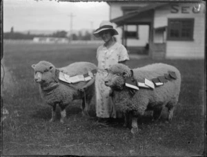 View of a young lady [Manson?] kneeling with her two prize winning sheep, Hawke's Bay District