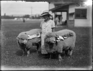 View of a young lady [Manson?] kneeling with her two prize winning sheep, Hawke's Bay District