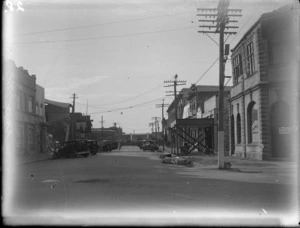 Queen Street, Hastings, showing buildings, parked motor cars and business of Stickland & Bryant, probably after the Hawkes Bay earthquake
