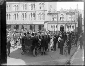 A large crowd of men with bicycles and a pedicab from Inglis Brothers gathered in Cathedral Square, Christchurch