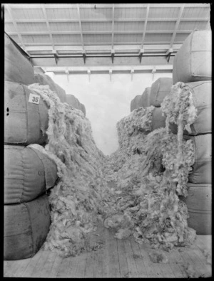 Wool samples spilling from bales in an unidentified warehouse