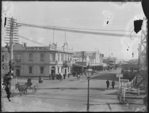 Corner of Main Street and Railway Road, Heretaunga, Hastings, showing a man on a horse and cart, man on a horse, man on a bicycle and people walking down the street