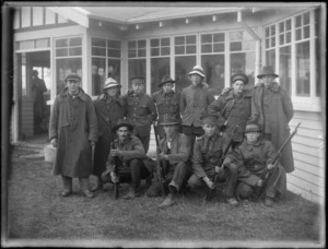 A group of unidentified soldiers, at casual camp, Hastings, with the soldiers kneeling in the front holdings rifles
