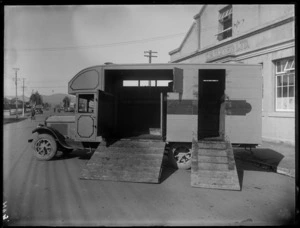 A side view of a horse float truck in front of the business premises of C H Slater Ltd, showing the horse accommodation, Hastings