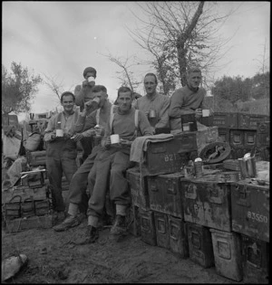 Members of NZ Infantry have a break by ammunition dump in the forward areas in Italy, World War II - Photograph taken by George Kaye