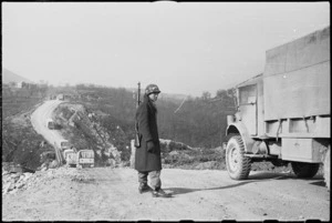 American MP directing NZ traffic at temporary bridge on the 5th Army Front in southern Italy, World War II - Photograph taken by George Kaye