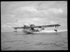 A Consolidated Catalina flying boat XX-P, skimming across water, location unidentified