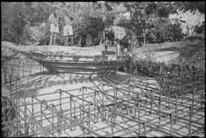 New Zealand soldier inspecting partially constructed enemy defence post in Riccione, Italy, World War II - Photograph taken by George Kaye