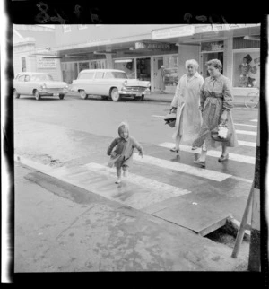 Unidentified woman and a small child [grandmother, mother, child?] on pedestrian crossing, Masterton, Wairarapa Region