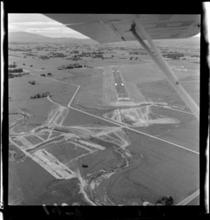 Aerial view of airport under construction, Palmerston North, Manawatu-Whanganui Region, including runway and sites cleared for buildings