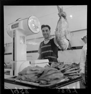 Fish monger J A Zino holding 9 1/4 pound snapper with smaller fish in foreground