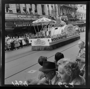 Festival of Wellington parade, showing Woolworths parade float, spectators, and businesses premises including Tisdalls Sports Depot and the Carlton Hotel, Willis Street, Wellington