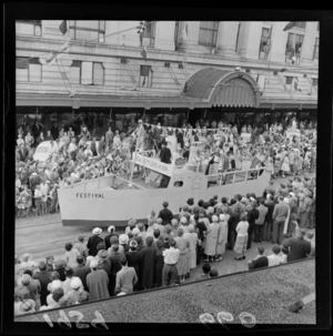 Festival of Wellington parade, showing New Settlers Association float, and spectators, outside DIC building, Lambton Quay, Wellington