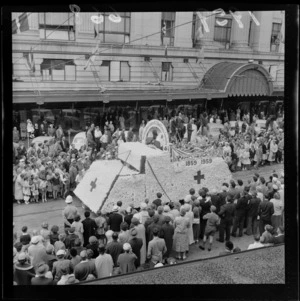 Festival of Wellington parade, showing the New Zealand Red Cross Society parade float, and spectators, outside the DIC building, Lambton Quay, Wellington