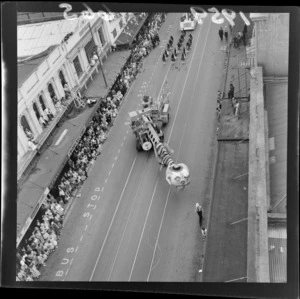 Festival of Wellington parade, showing parade floats, marching girls and spectators outside Kean's building and Woolworths, [Willis Street?], Wellington