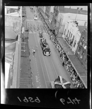Willis Street, Wellington, during Festival of Wellington parade, showing Royal New Zealand Naval Volunteer Reserve float, spectators, and businesses including Thomsen's Silk Shop, McKenzies department store, and Wardells Supermarket