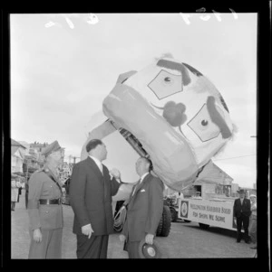 Unidentified men standing in front of a Festival of Wellington parade float, with Wellington Harbour Board parade float in background, Wellington