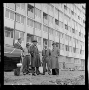 Group of men in front of block of state flats, The Terrace, Wellington