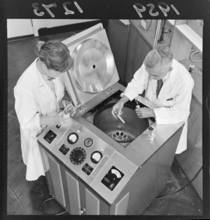 Unidentified man and woman in laboratory coats [professor? student?] conducting test with centrifuge machine at the Chemistry Department of Victoria University, Wellington