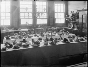 Tables laid with cakes and food in a home science classroom