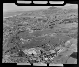 View to Green Island settlement, showing Burnside Freezing Works Saddle Hill with stock yards in foreground, to Dunedin Southern Motorway (State Highway 1), Kaikorai Stream and estuary, to Brighton and south coast beyond