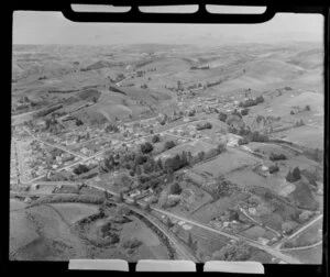 View over Lawrence, Otago, showing settlement with residential housing amongst farmland, with Beaumont Highway (State highway 8) through town