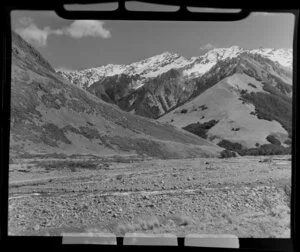 Lake Ohau, Central Otago, view of upper Temple Valley with shingle covered riverbed and stream foreground, to trees on higher slopes of valley and snow covered mountains beyond