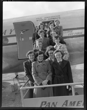 Close-up view of a group of women on stairs disembarking from Pan American World Airways plane, East Indian PAA number 888, Whenuapai, Auckland City