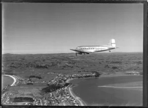 New Zealand National Airways Corporation (NAC) Flagship Dakota aircraft in flight over Auckland