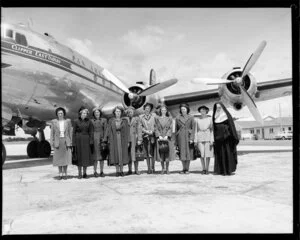 Unidentified group, next to Pan American Airways aircraft, Whenuapai airport, Auckland