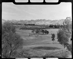 Golfers on the links with a backdrop of mountains, Hanmer Springs, Canterbury